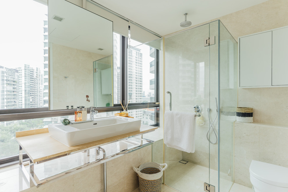 Design ideas for a contemporary bathroom in Singapore with a corner shower, beige tile, a vessel sink, beige floor, a hinged shower door and beige benchtops.