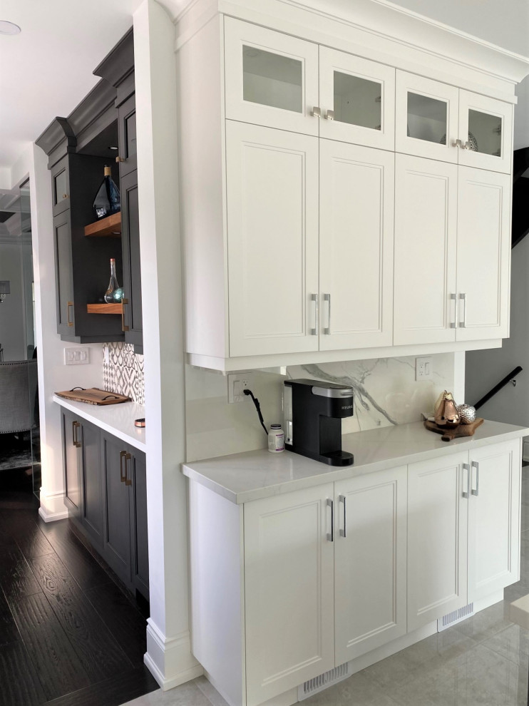 Inspiration for a large transitional l-shaped porcelain tile and white floor open concept kitchen remodel in Toronto with an undermount sink, recessed-panel cabinets, white cabinets, quartz countertops, white backsplash, stone slab backsplash, stainless steel appliances, an island and white countertops