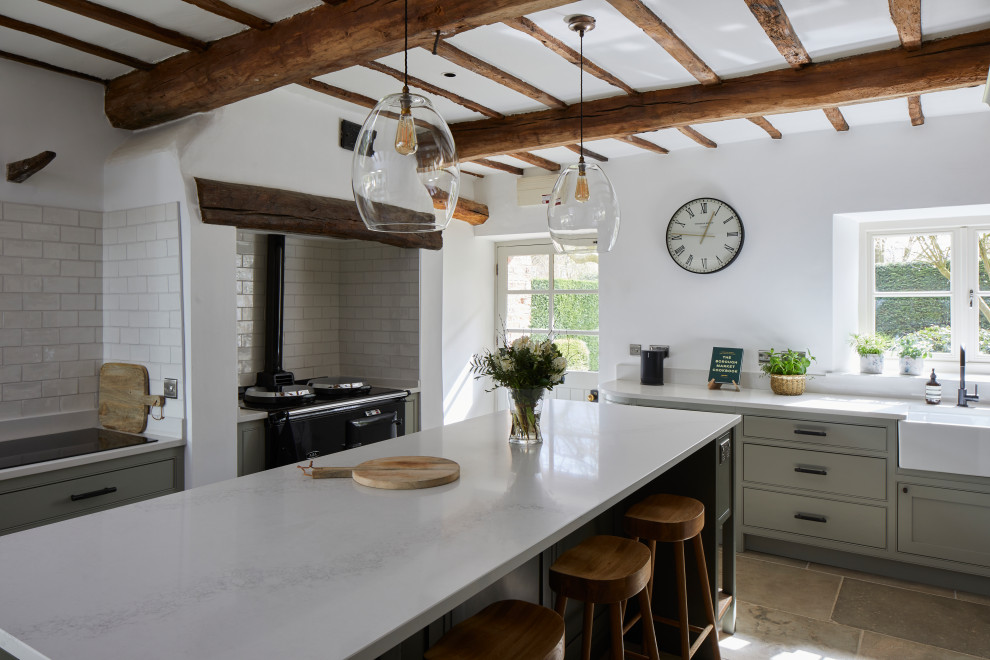 Inspiration for a country u-shaped kitchen in Other with a belfast sink, beaded cabinets, grey cabinets, white splashback, black appliances, an island, grey floors, white worktops and exposed beams.