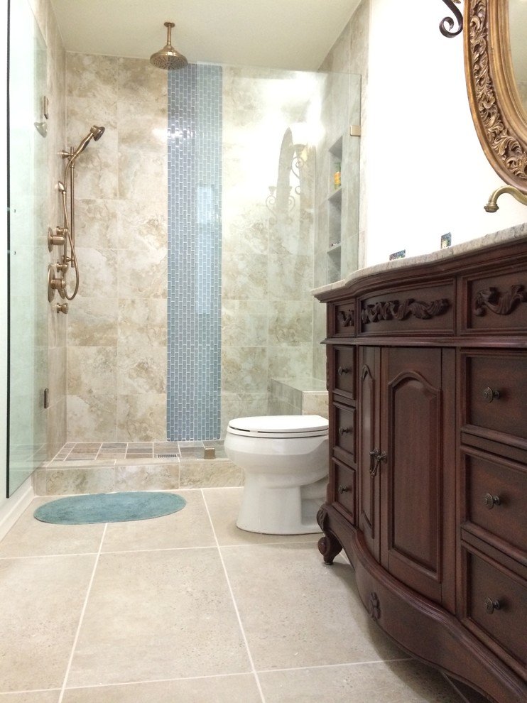 Large traditional master bathroom in Dallas with raised-panel cabinets, dark wood cabinets, an open shower, beige tile, porcelain tile, grey walls, porcelain floors, an undermount sink, granite benchtops, grey floor, a hinged shower door and brown benchtops.