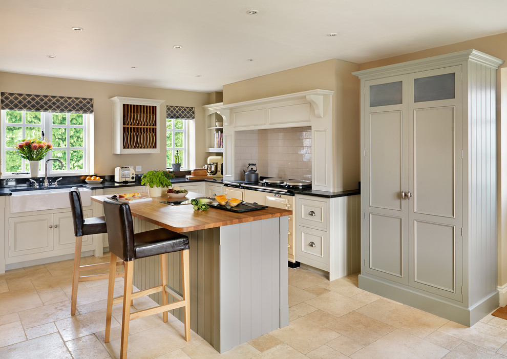 This is an example of a traditional l-shaped kitchen in London with coloured appliances and with island.