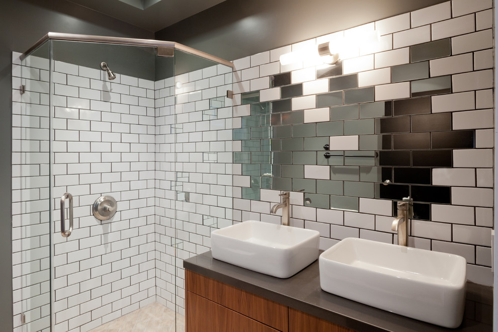 This is an example of a contemporary bathroom in Los Angeles with a vessel sink, medium wood cabinets, a corner shower, multi-coloured tile, subway tile and grey walls.