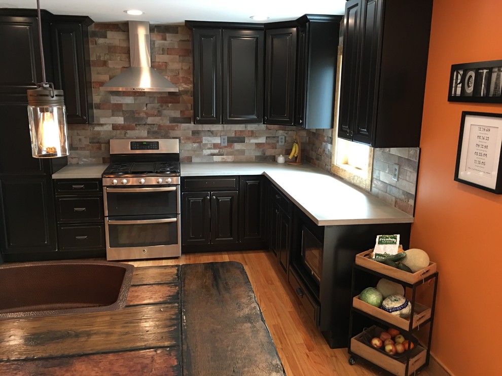Example of a mountain style kitchen design in New York with concrete countertops