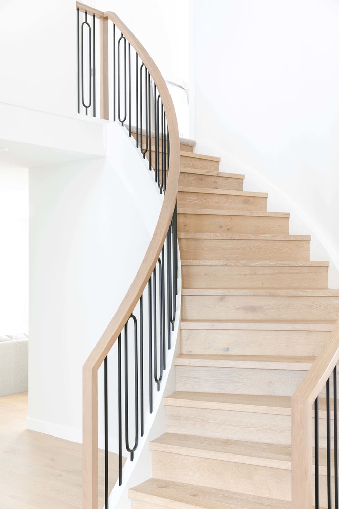 Inspiration for a large transitional wooden spiral mixed material railing staircase remodel in Calgary with wooden risers