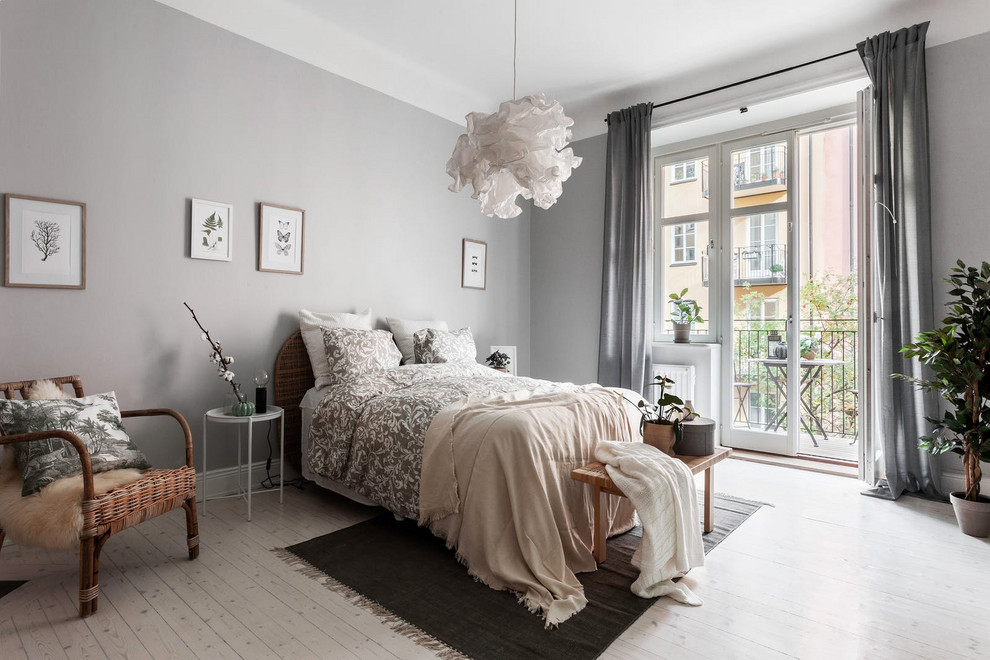 Photo of a scandinavian bedroom in Stockholm with grey walls, light hardwood floors and beige floor.
