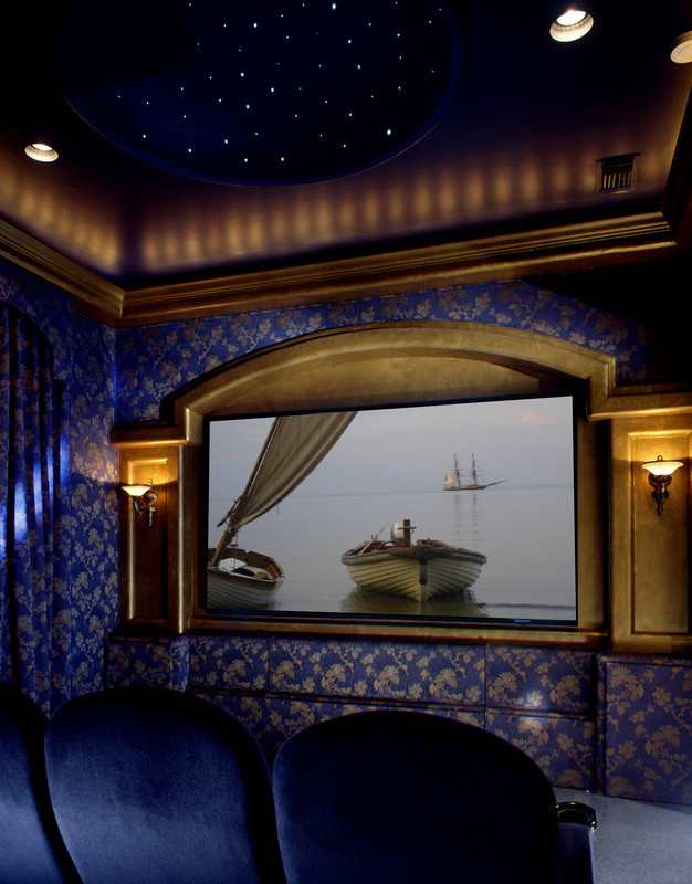 This is an example of a mid-sized enclosed home theatre in San Diego with blue walls, carpet and a built-in media wall.