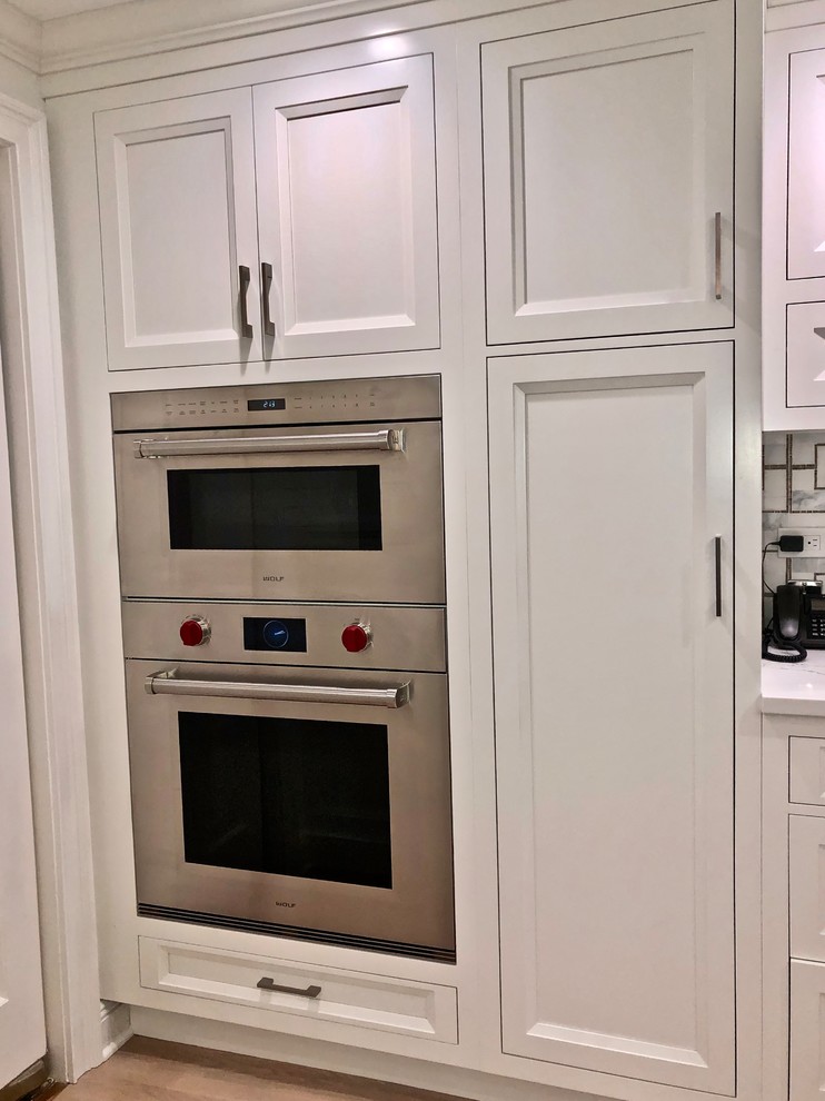 Eat-in kitchen - large transitional eat-in kitchen idea in New York with beaded inset cabinets, gray cabinets, quartz countertops and an island