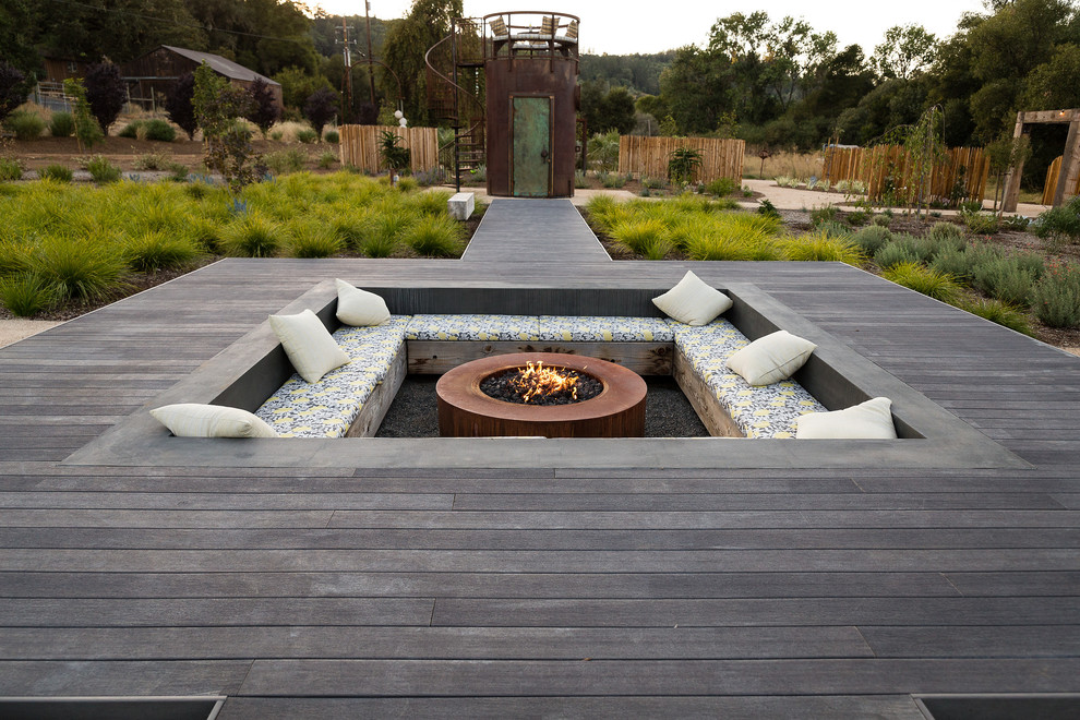 Country backyard deck in Other with a fire feature and no cover.