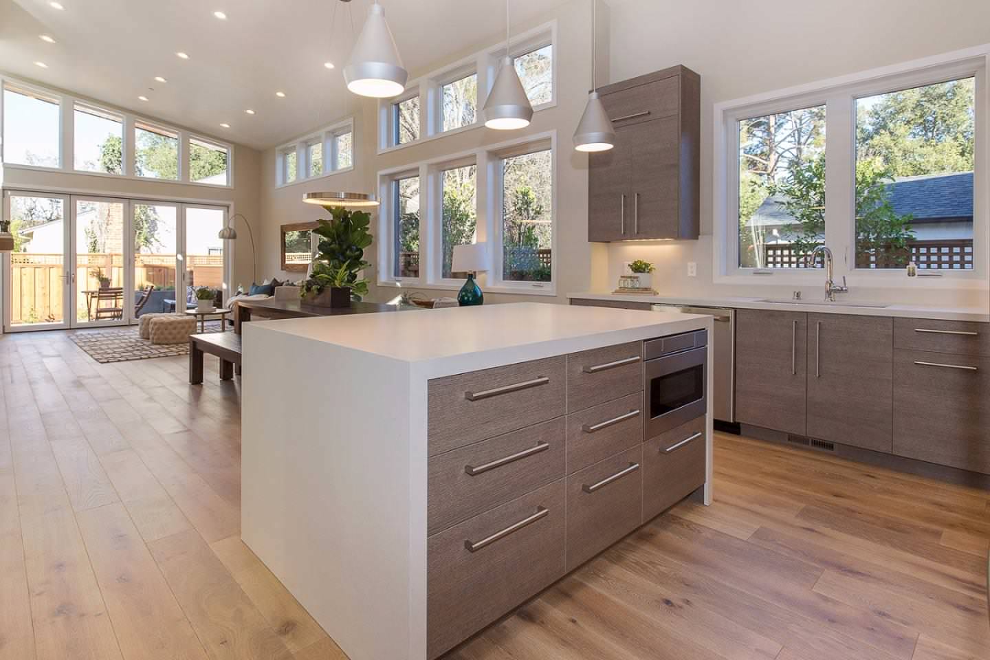 Large trendy light wood floor and brown floor kitchen photo in San Francisco with an undermount sink, flat-panel cabinets, medium tone wood cabinets, quartz countertops, stainless steel appliances and
