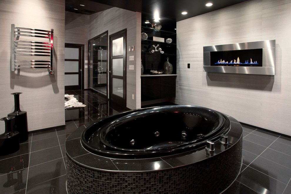 Inspiration for a contemporary bathroom in Seattle with a drop-in tub, black tile and black floor.