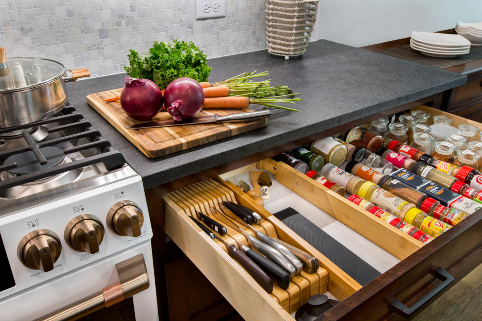 Design ideas for a mid-sized transitional galley eat-in kitchen in Other with an undermount sink, shaker cabinets, brown cabinets, granite benchtops, white splashback, mosaic tile splashback, white appliances, medium hardwood floors, no island, brown floor and black benchtop.