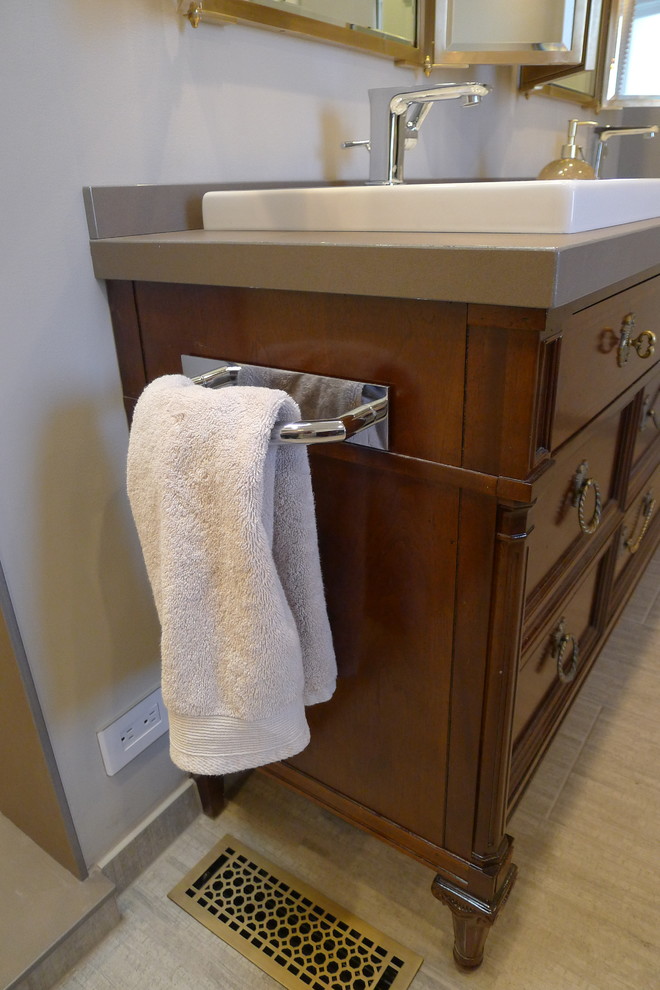 Example of a large transitional master gray tile and porcelain tile porcelain tile home design design in Indianapolis with a drop-in sink, furniture-like cabinets, dark wood cabinets, solid surface countertops, a one-piece toilet and gray walls