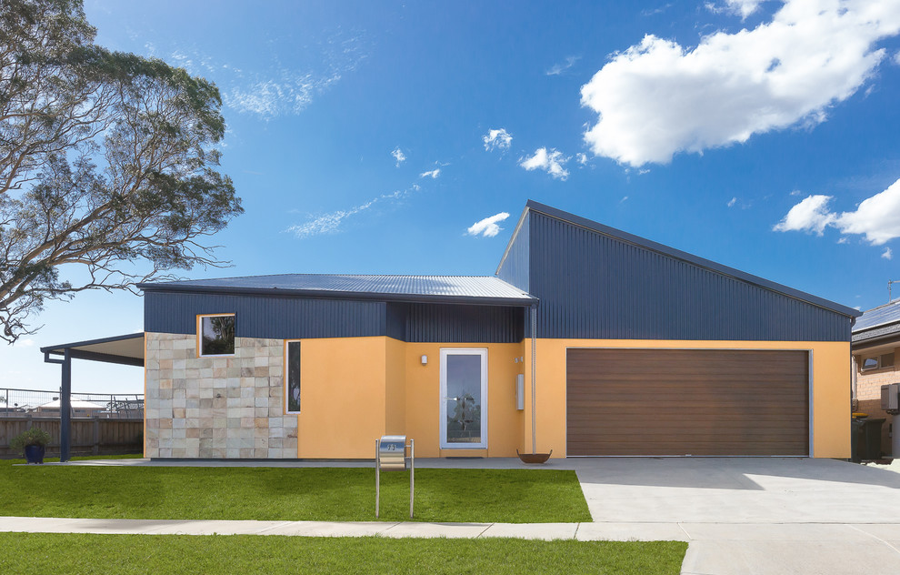 Inspiration for a small modern one-storey house exterior in Melbourne with a metal roof.
