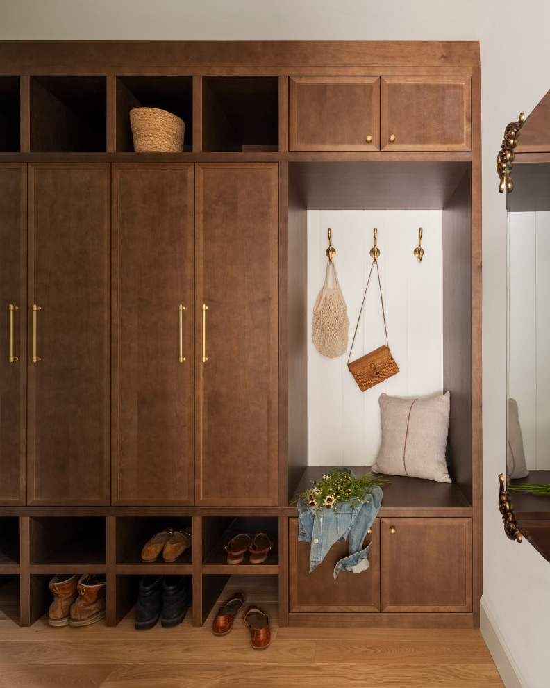 Mid-sized elegant light wood floor mudroom photo in Seattle with white walls