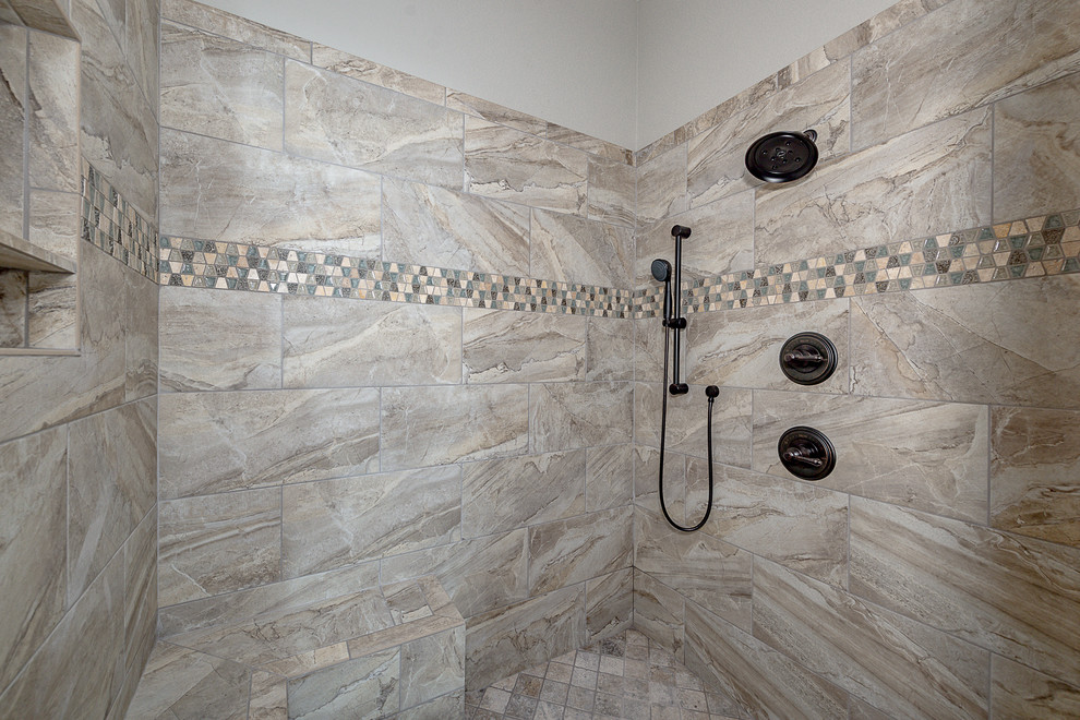 This is an example of a mid-sized country master bathroom in Other with shaker cabinets, grey cabinets, a corner shower, a two-piece toilet, beige tile, ceramic tile, grey walls, ceramic floors, an undermount sink, granite benchtops, beige floor and a hinged shower door.