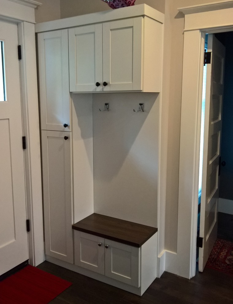 Small elegant dark wood floor mudroom photo with beige walls