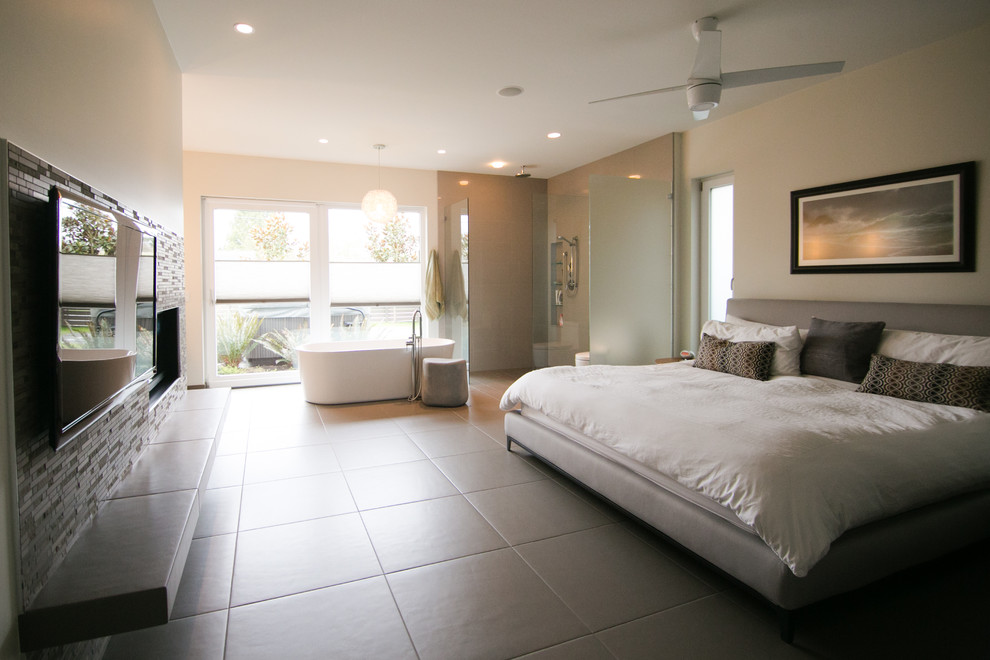 Design ideas for a large modern master bedroom in Vancouver with grey walls, ceramic floors, a standard fireplace and a tile fireplace surround.