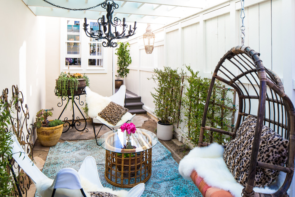 Small eclectic courtyard patio in Los Angeles with a container garden, a pergola and concrete pavers.