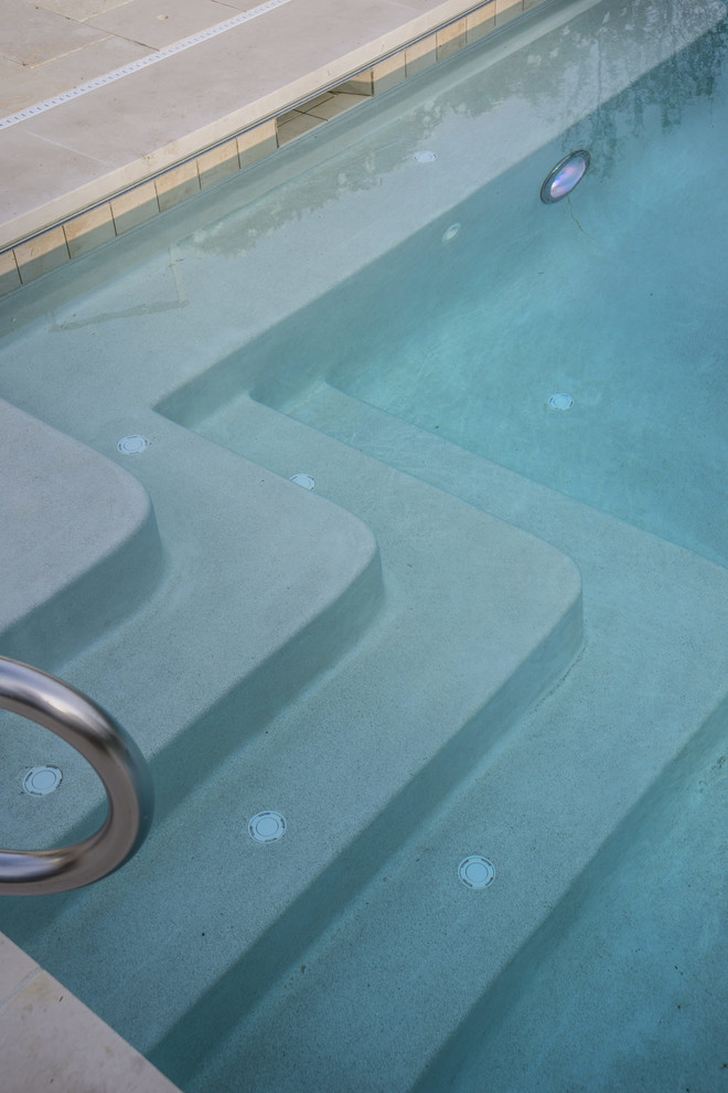 Mid-sized minimalist backyard stone and rectangular pool photo in Chicago