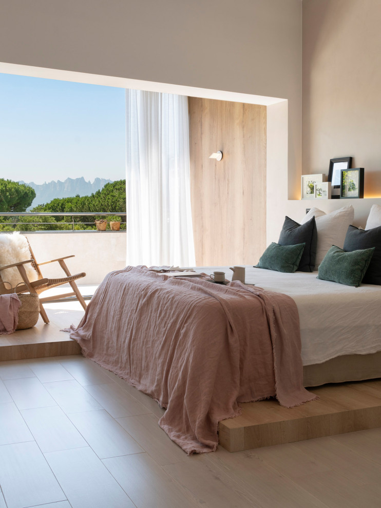 This is an example of a scandinavian master bedroom in Barcelona with beige walls, light hardwood floors and beige floor.