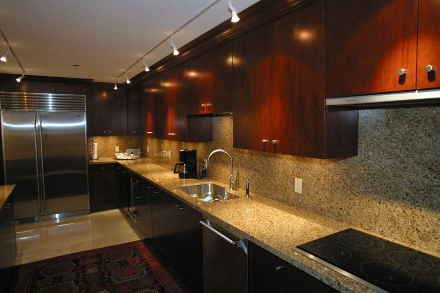 Kitchen - large transitional kitchen idea in Miami with an undermount sink, flat-panel cabinets, medium tone wood cabinets, granite countertops, beige backsplash, stainless steel appliances and an island