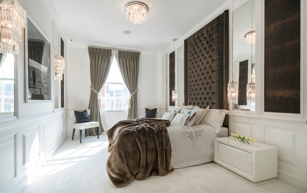 Inspiration for a large contemporary master bedroom in London with white walls and carpet.