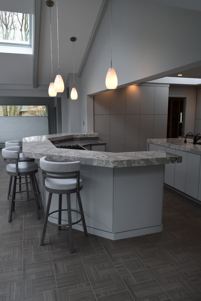 Minimalist ceramic tile and gray floor kitchen photo with an undermount sink, flat-panel cabinets, gray cabinets, quartz countertops, multicolored backsplash, glass tile backsplash, paneled appliances, an island and gray countertops