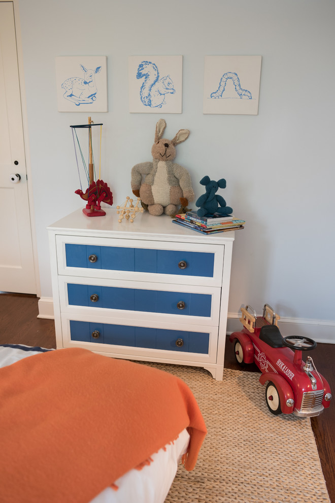 This is an example of a mid-sized country kids' bedroom for kids 4-10 years old and boys in New York with grey walls and dark hardwood floors.