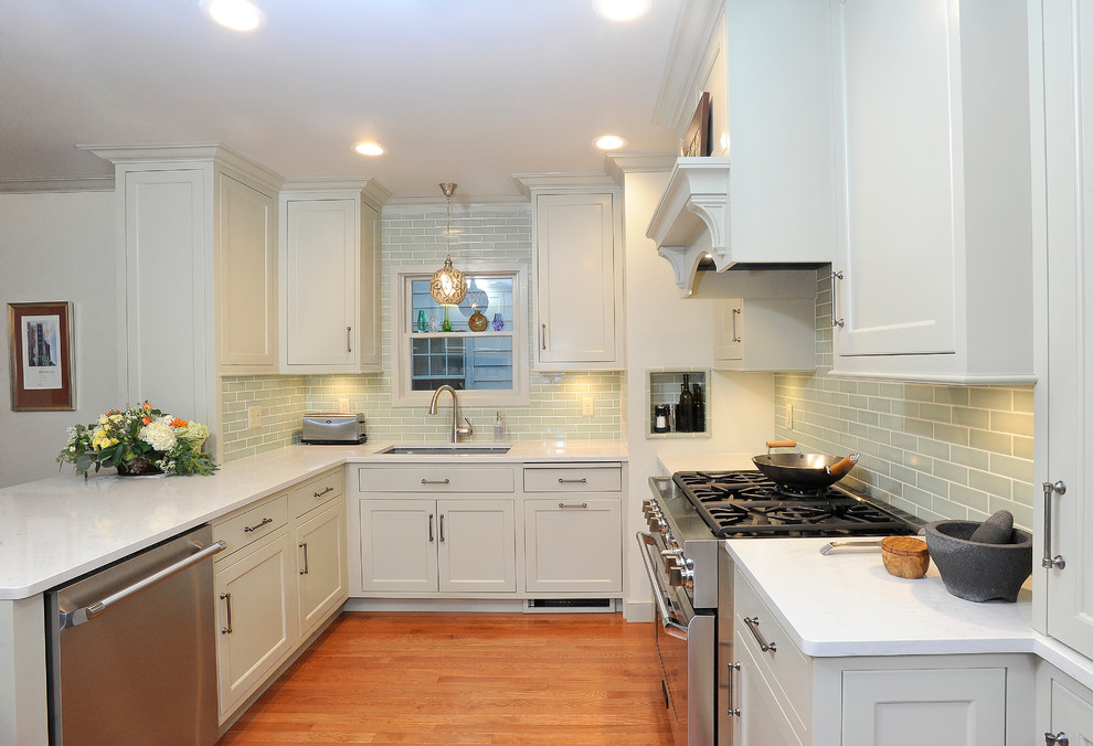 Small transitional u-shaped medium tone wood floor eat-in kitchen photo with an undermount sink, flat-panel cabinets, gray cabinets, quartz countertops, green backsplash, subway tile backsplash, stainless steel appliances and a peninsula