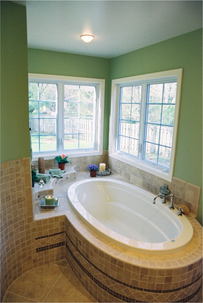Example of a mid-sized master beige tile and ceramic tile ceramic tile drop-in bathtub design in Grand Rapids with green walls