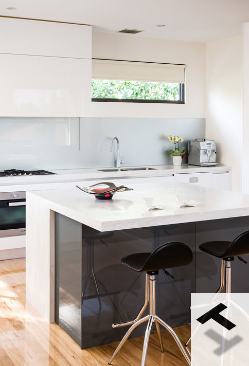 Design ideas for a modern kitchen in Melbourne with an integrated sink, white cabinets, solid surface benchtops, metallic splashback, glass sheet splashback, black appliances and light hardwood floors.