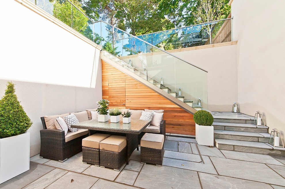 This is an example of a contemporary patio in Surrey with no cover.