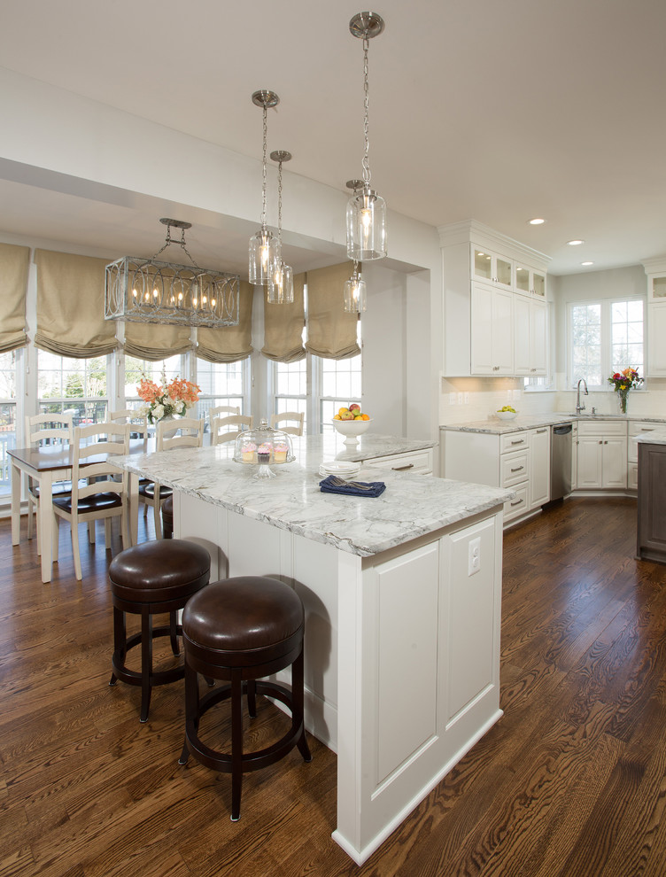 This is an example of a large transitional u-shaped eat-in kitchen in DC Metro with granite benchtops, stainless steel appliances and multiple islands.