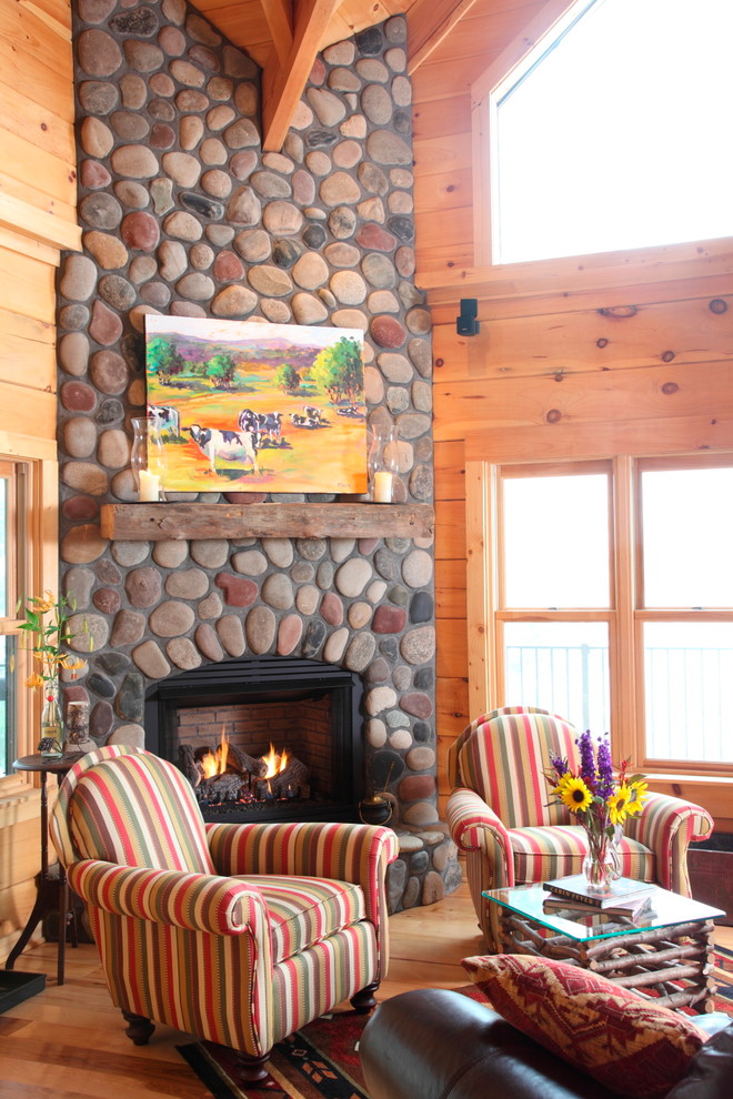 Inspiration for a rustic living room remodel in Charlotte with a corner fireplace and a stone fireplace