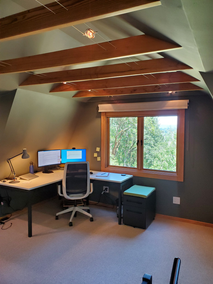 Example of a small trendy freestanding desk carpeted, black floor and exposed beam home studio design in San Francisco with green walls and no fireplace