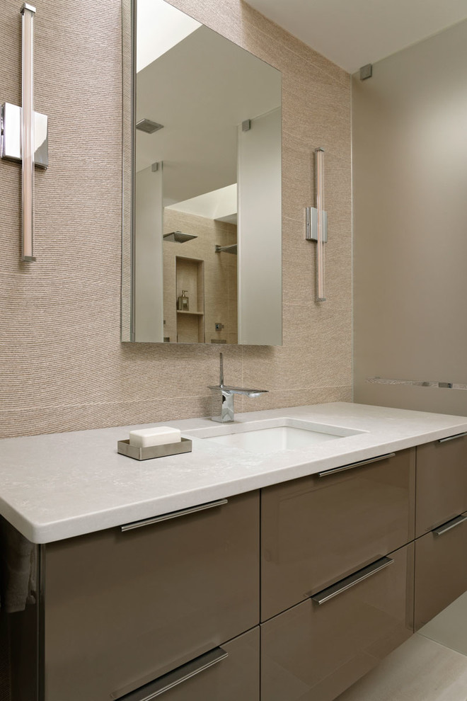 Design ideas for a mid-sized modern master bathroom in DC Metro with flat-panel cabinets, beige cabinets, an open shower, a one-piece toilet, beige tile, porcelain tile, beige walls, light hardwood floors, a drop-in sink, engineered quartz benchtops, beige floor and an open shower.