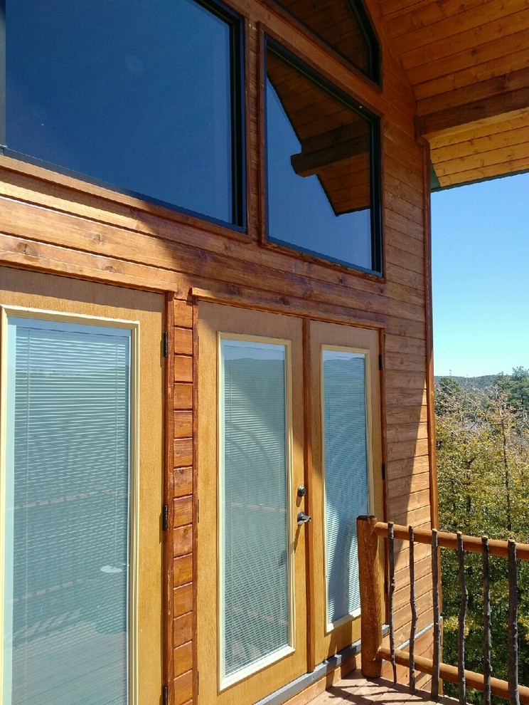 Inspiration for a mid-sized rustic backyard deck remodel in Phoenix with a roof extension