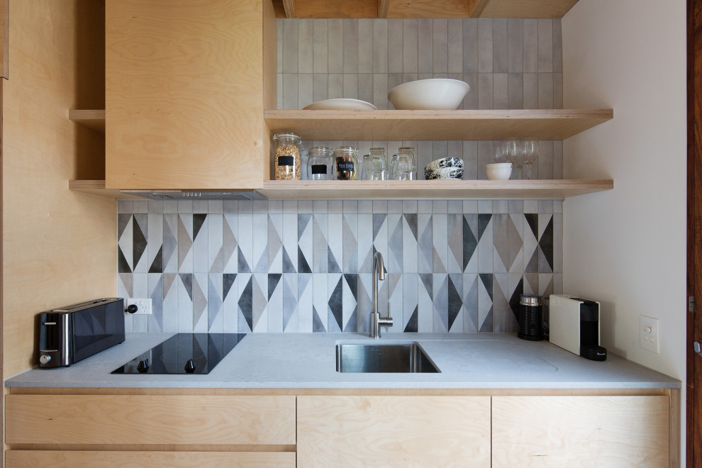 Photo of a small contemporary single-wall kitchen in Sydney with an undermount sink, light wood cabinets, quartz benchtops, ceramic splashback, concrete floors and timber.