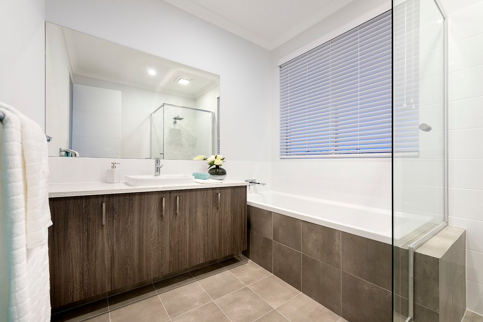 This is an example of a mid-sized modern kids bathroom in Perth with flat-panel cabinets, dark wood cabinets, a corner shower, beige tile, porcelain tile, white walls, ceramic floors, a drop-in sink and engineered quartz benchtops.