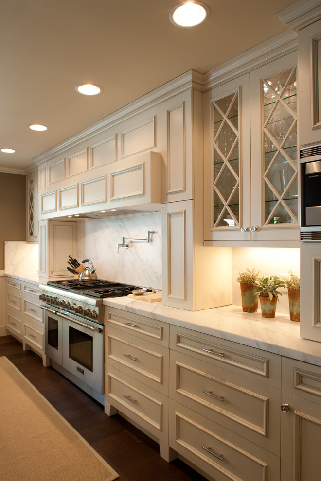 Photo of a contemporary kitchen in Salt Lake City with recessed-panel cabinets, marble benchtops, beige cabinets, white splashback and stone slab splashback.