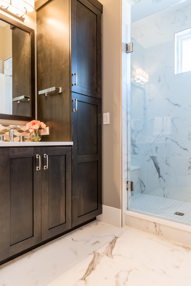 This is an example of a transitional master bathroom in Denver with shaker cabinets, dark wood cabinets, gray tile, mosaic tile, grey walls, an undermount sink, quartzite benchtops, a freestanding tub, an open shower, a one-piece toilet, marble floors and an open shower.