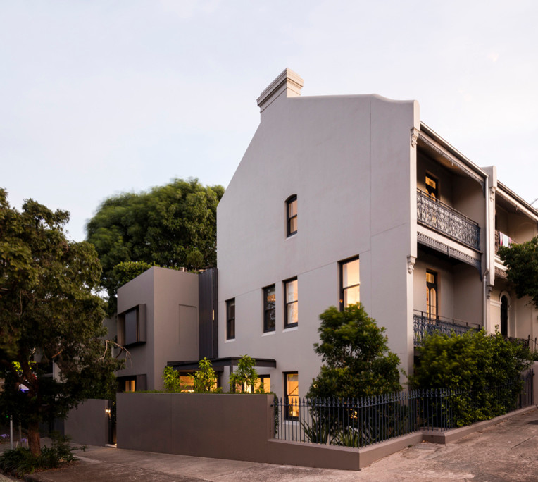 Inspiration for a large modern three-storey stucco beige exterior in Sydney with a flat roof.