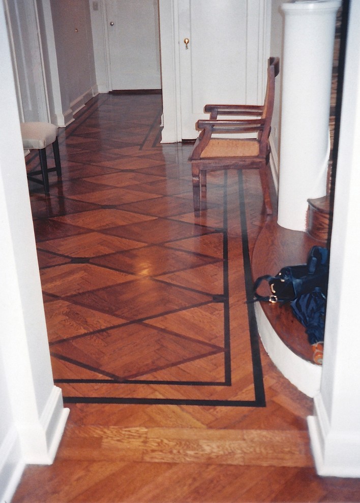 Photo of a mid-sized modern foyer in New York with white walls, medium hardwood floors, a single front door and a white front door.