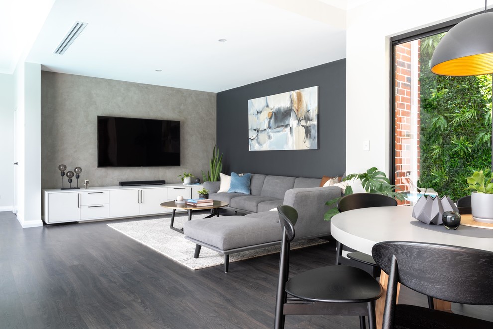 This is an example of an industrial living room in Perth with laminate floors.