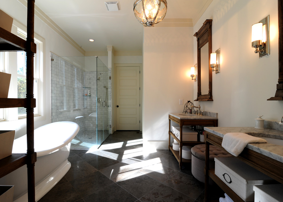Design ideas for an arts and crafts master bathroom in San Francisco with an undermount sink, shaker cabinets, beige cabinets, marble benchtops, a freestanding tub, a corner shower, a two-piece toilet, gray tile, porcelain tile, grey walls and porcelain floors.