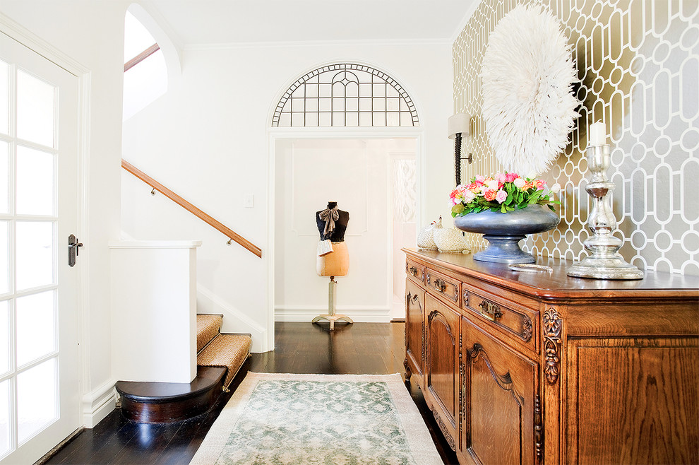 This is an example of an eclectic entryway in Los Angeles with dark hardwood floors.