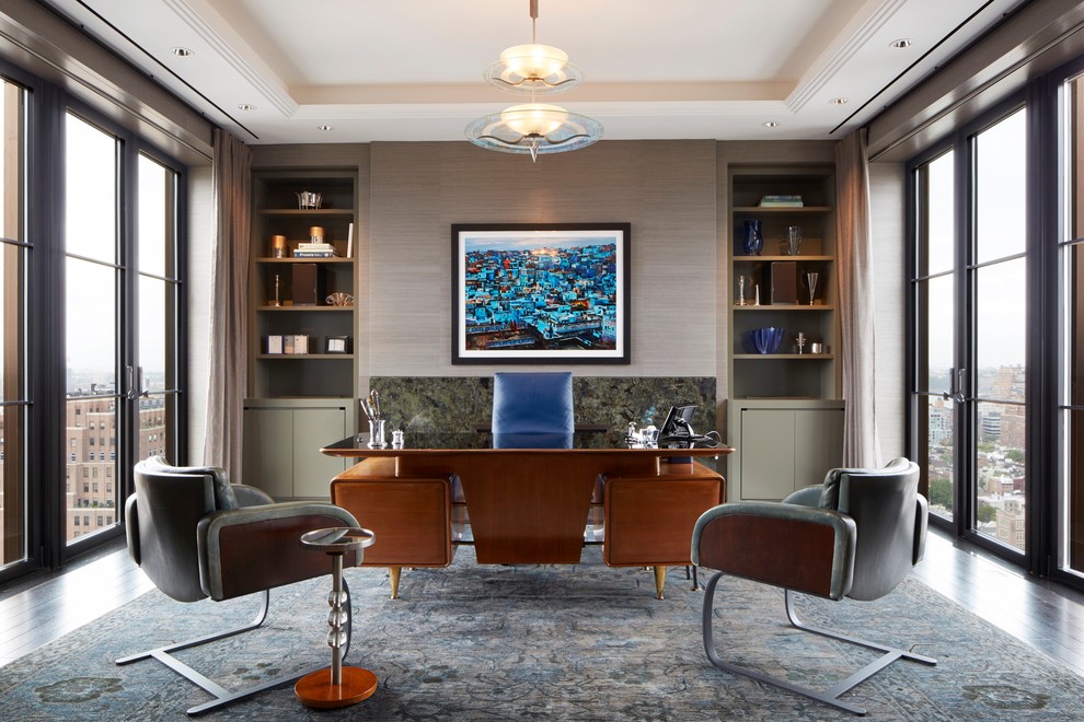 Large contemporary study room in New York with dark hardwood floors, a freestanding desk and grey walls.