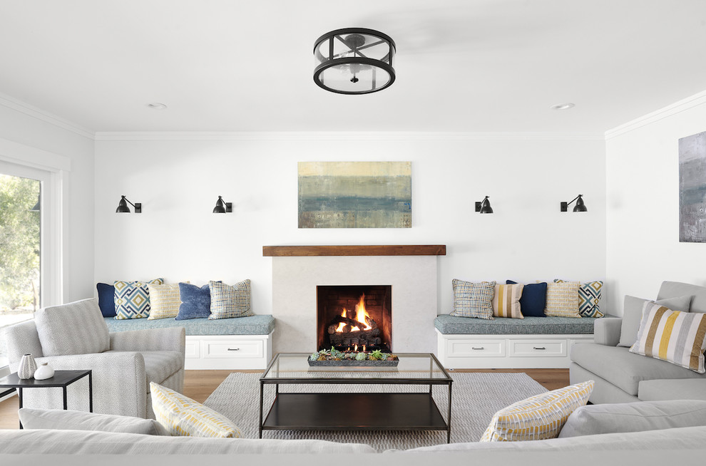 Inspiration for a mid-sized transitional open concept family room in San Francisco with white walls, medium hardwood floors, a standard fireplace, a tile fireplace surround and brown floor.