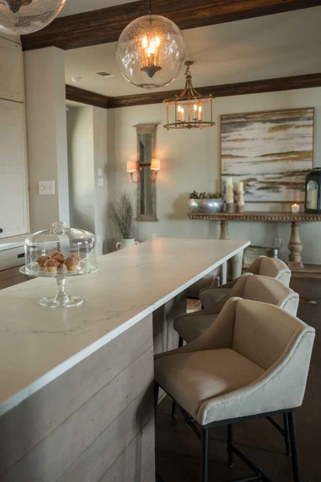 Large transitional galley dark wood floor and brown floor open concept kitchen photo with a farmhouse sink, shaker cabinets, quartz countertops, brown backsplash, brick backsplash, stainless steel appliances and an island