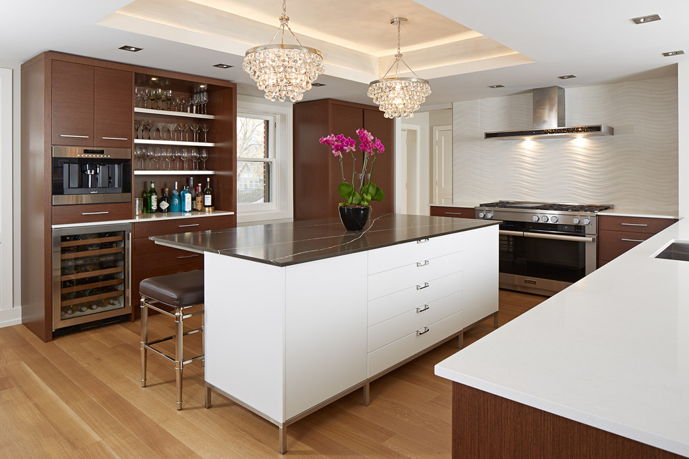 This is an example of a mid-sized contemporary kitchen in Minneapolis with flat-panel cabinets, quartz benchtops, white splashback, ceramic splashback, an undermount sink, dark wood cabinets, stainless steel appliances and light hardwood floors.